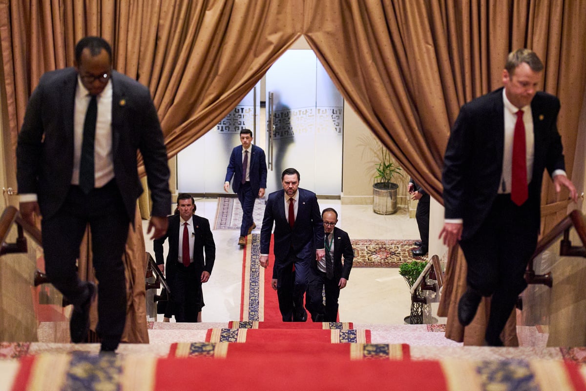 men in suits walk up stairs