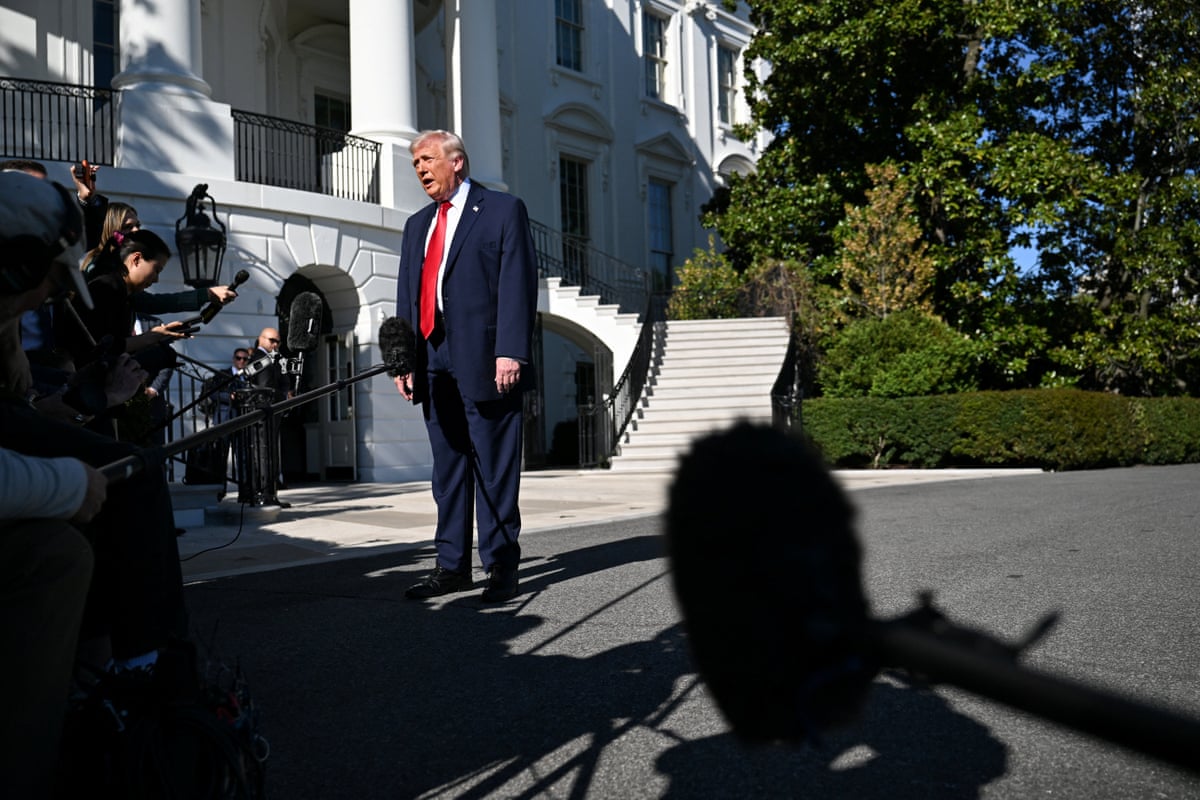 man in suit speaks outside to reporters