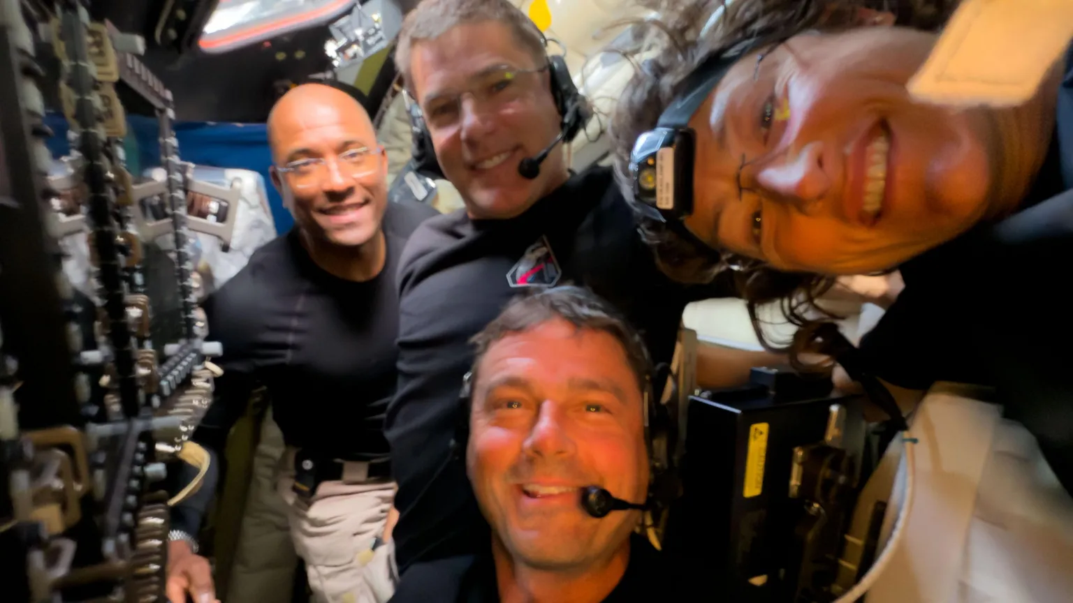 NASA Reid Wiseman, Victor Glover, Christina Koch and Jeremy Hansen pose for a selfie in the spacecraft