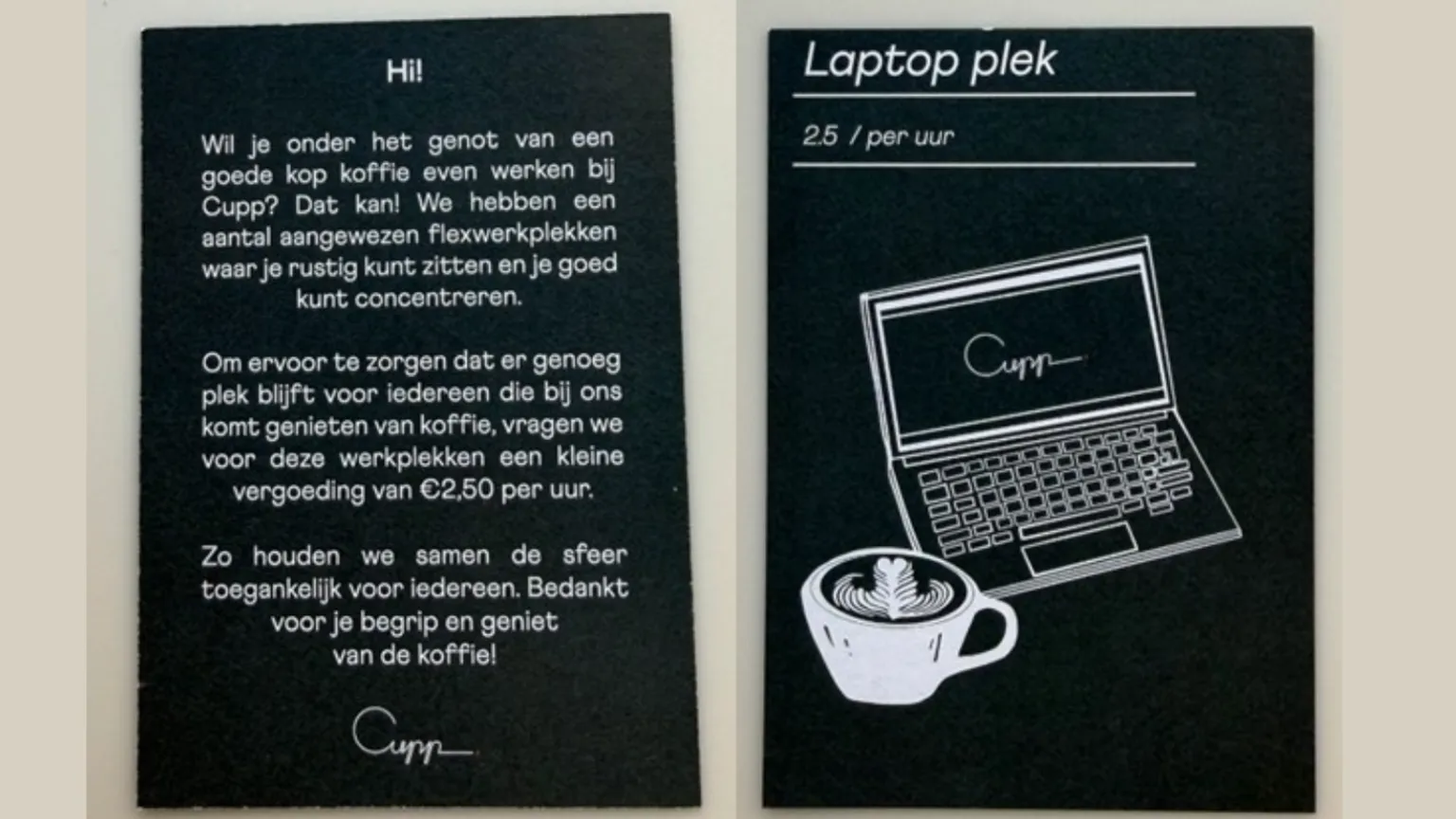 Steff Rees Two black signs with white writing in Dutch and an image of a laptop and a cup of coffee informing customers of the charge