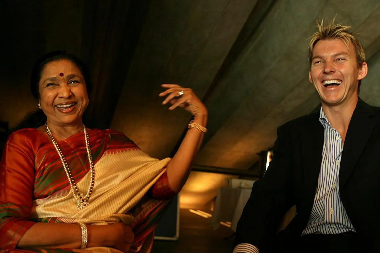 AFP Famous Indian singer Asha Bhosle with Australian cricketer Brett Lee who collaborated on a Bollywood single 'You're the One for Me'. Bhosle will be performing with The Kronos Quartet at The Sydney Opera House, 8 March 2007.