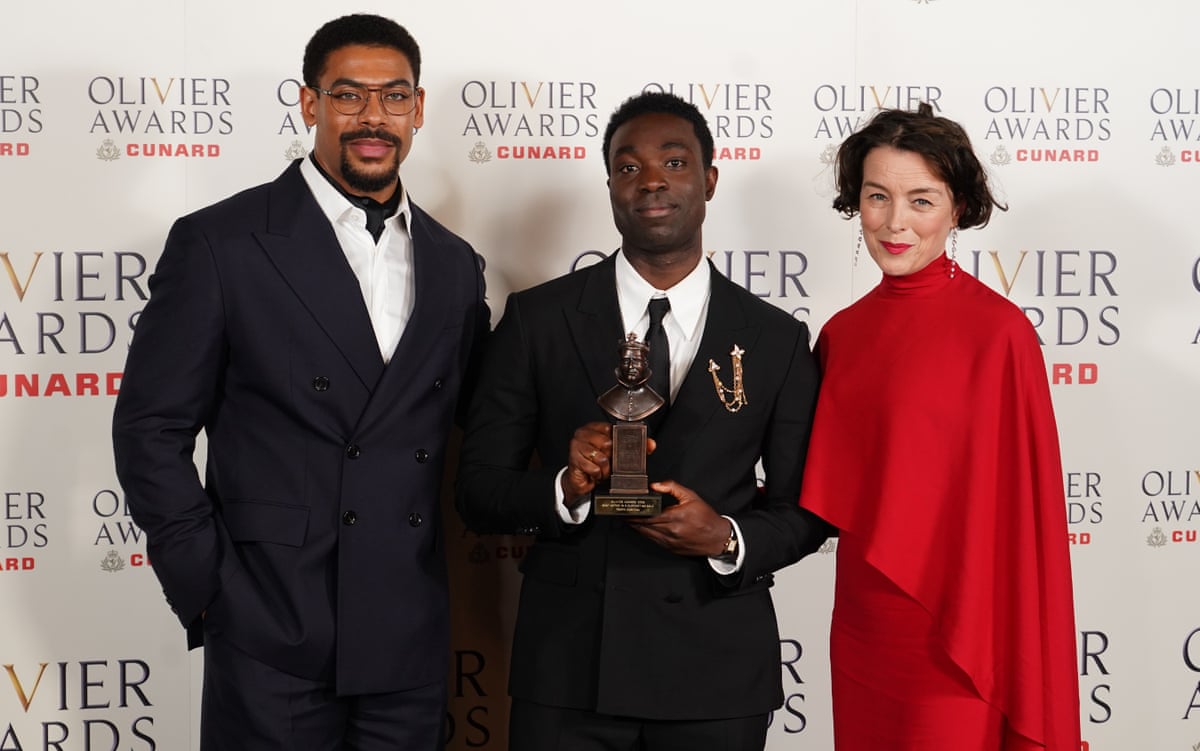 Paapa Essiedu, centre, with his best supporting actor award, and presenters Aaron Pierre and Olivia Williams.