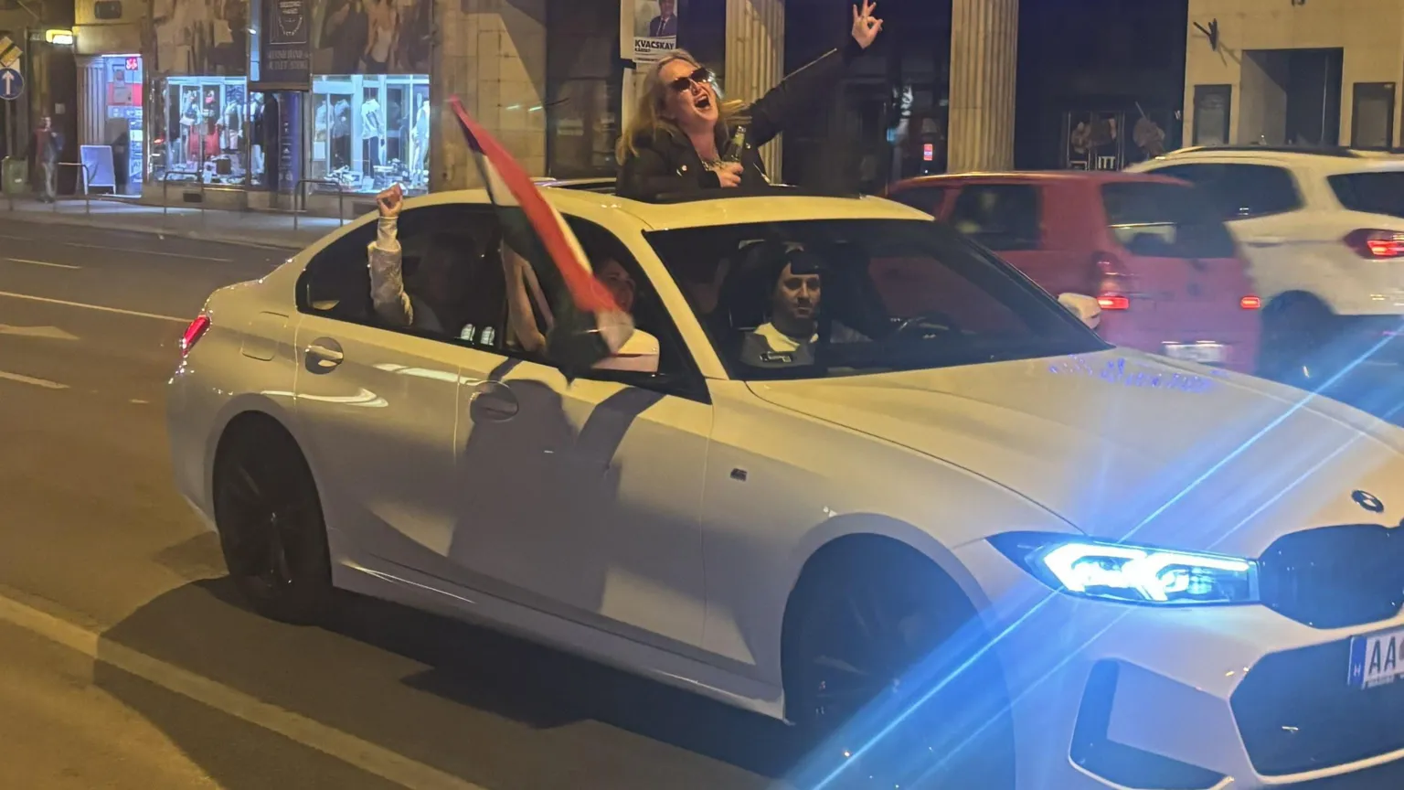 A woman with a flag in a car