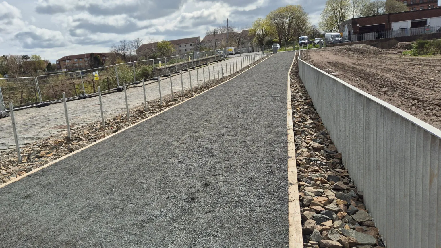A whin dust path leading towards a park