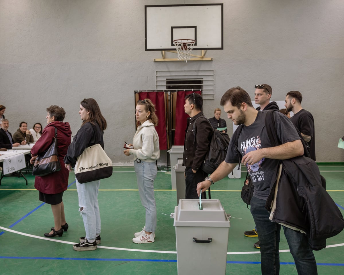 Voters arrive at a polling station to cast their ballots in Hungarian parliamentary elections on April 12, 2026 in Budapest, Hungary.