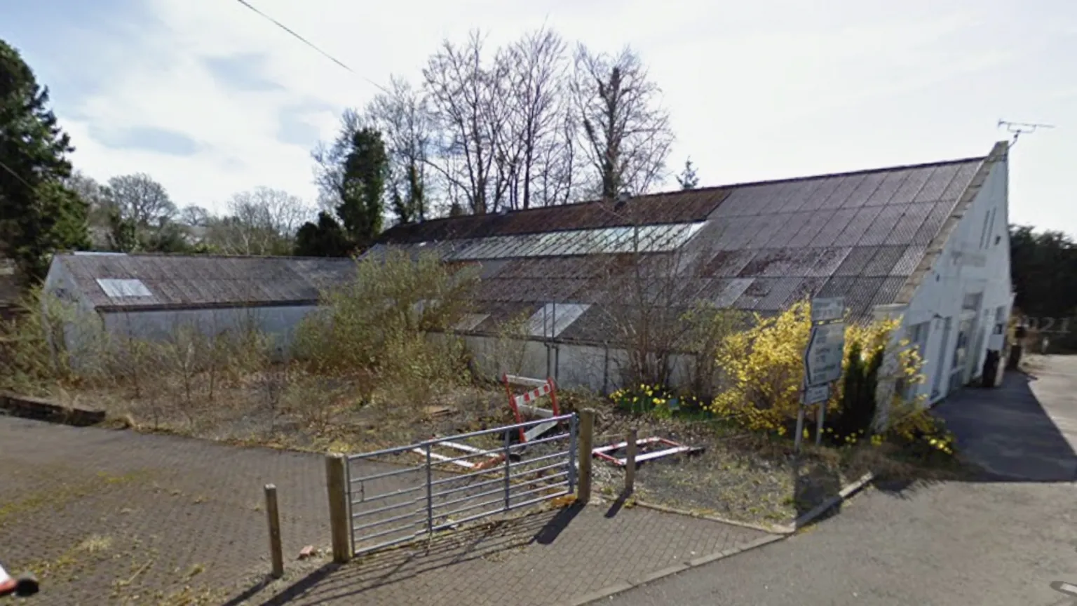 Google A run down overgrown garage