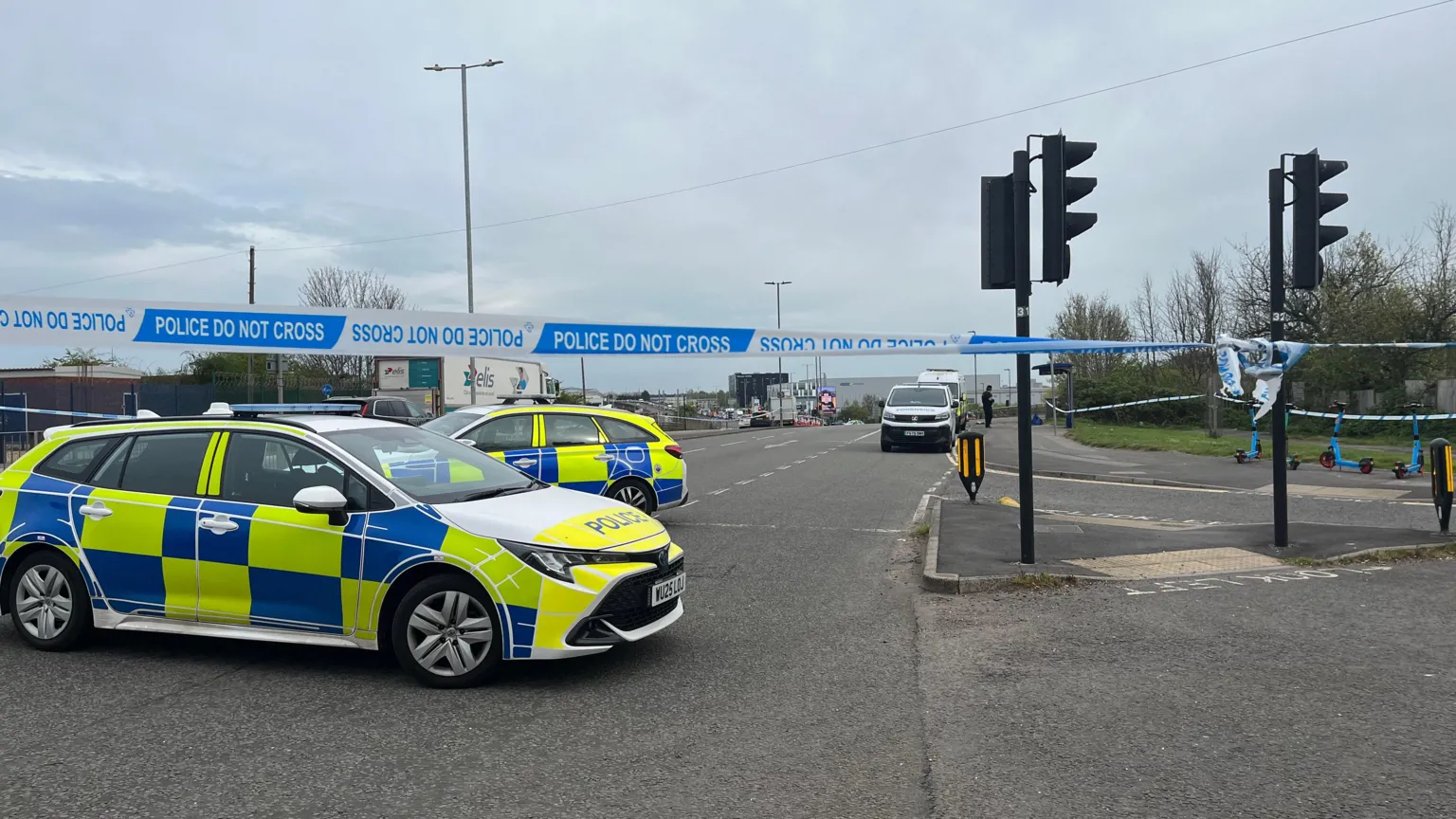 Two police cars and a police cordon on the intersection of a main road in Filton, north Bristol.
