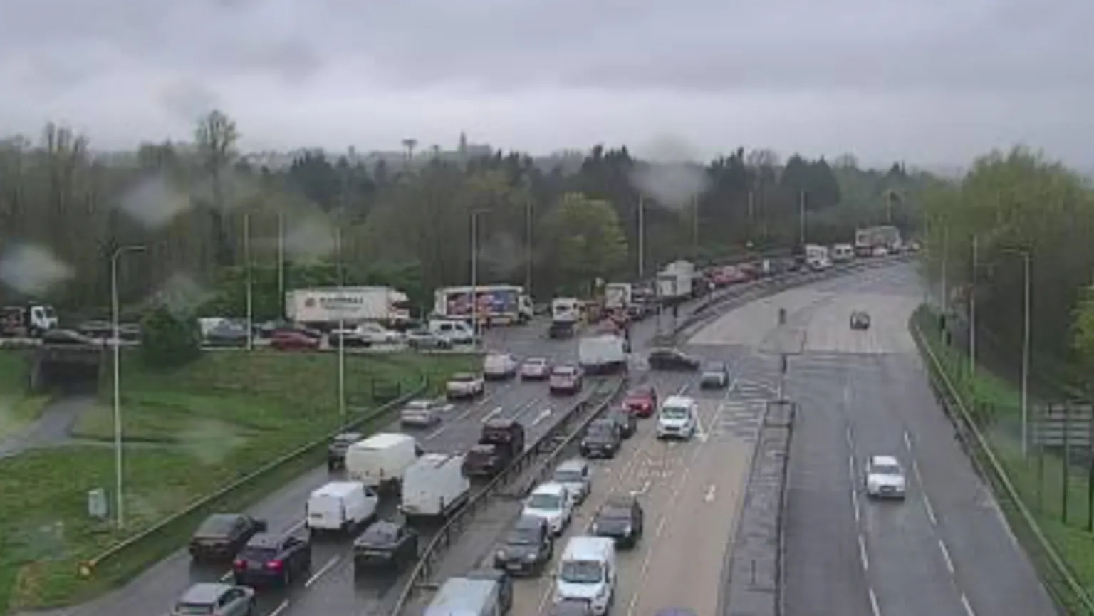 TrafficWatchNI Dozens of cars sit in a traffic jam on a stretch of road leading to the City Airport. There are other cars on other adjacent roads.