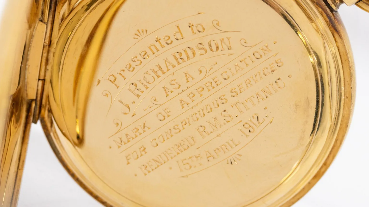 Hansons Auctioneers Close-up of a gold watch, engraved: