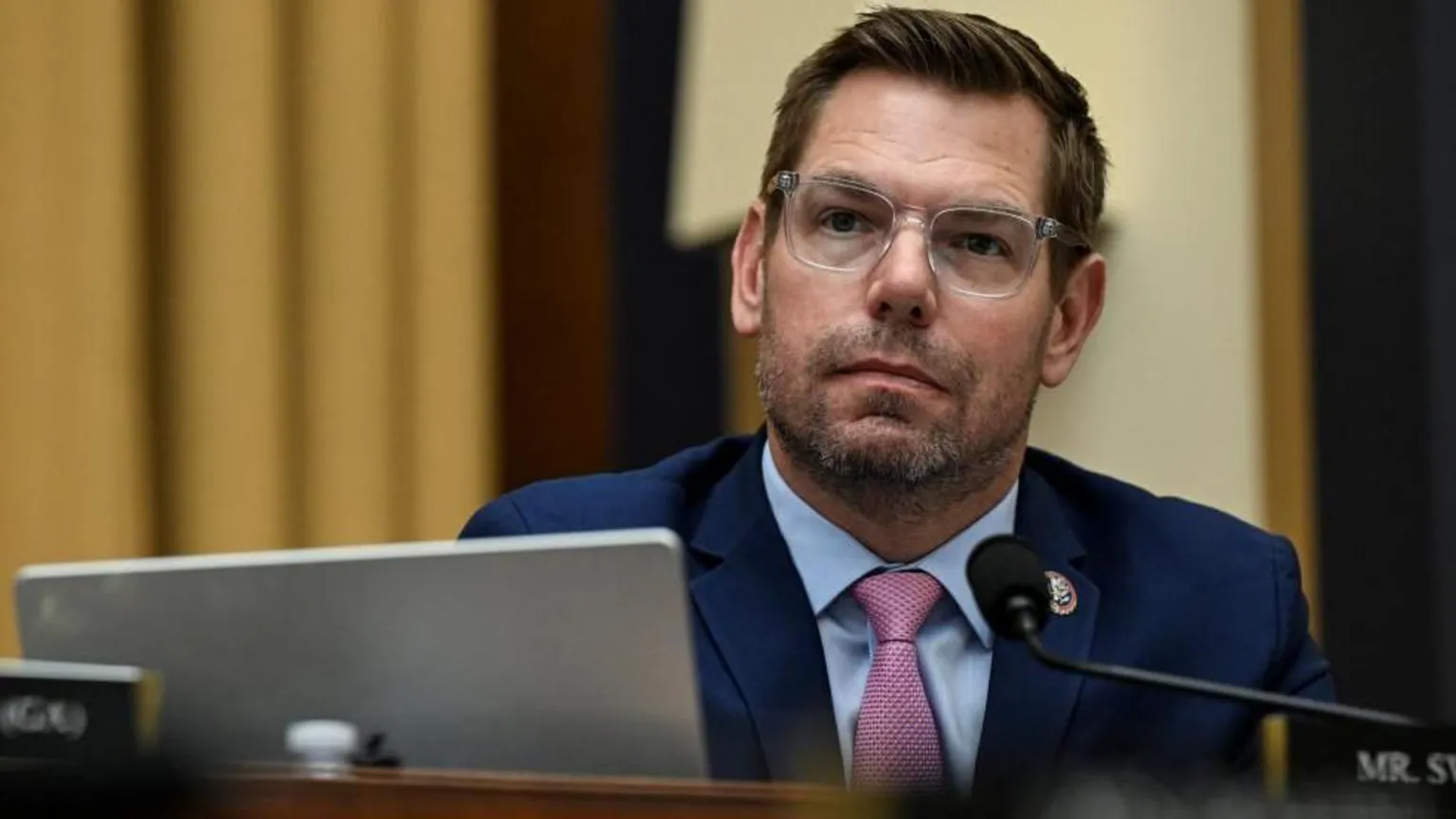  U.S. Representative Eric Swalwell wears a navy suit and transluscent-framed spectacles as he attends a House Judiciary Committee hearing