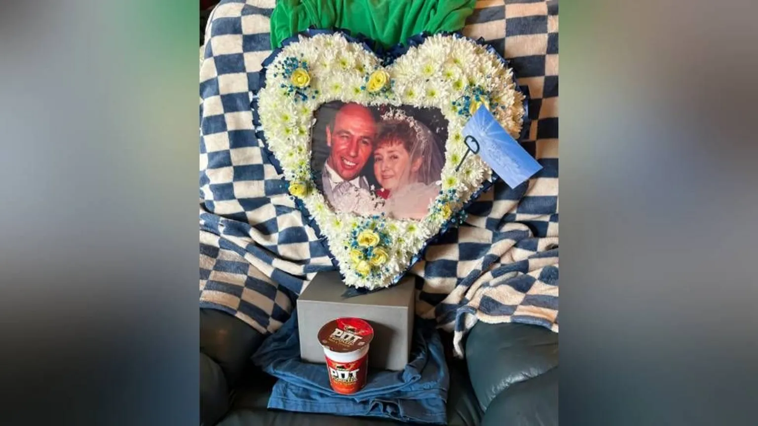 Family Photo A floral tribute in heart shape with a photo in the middle