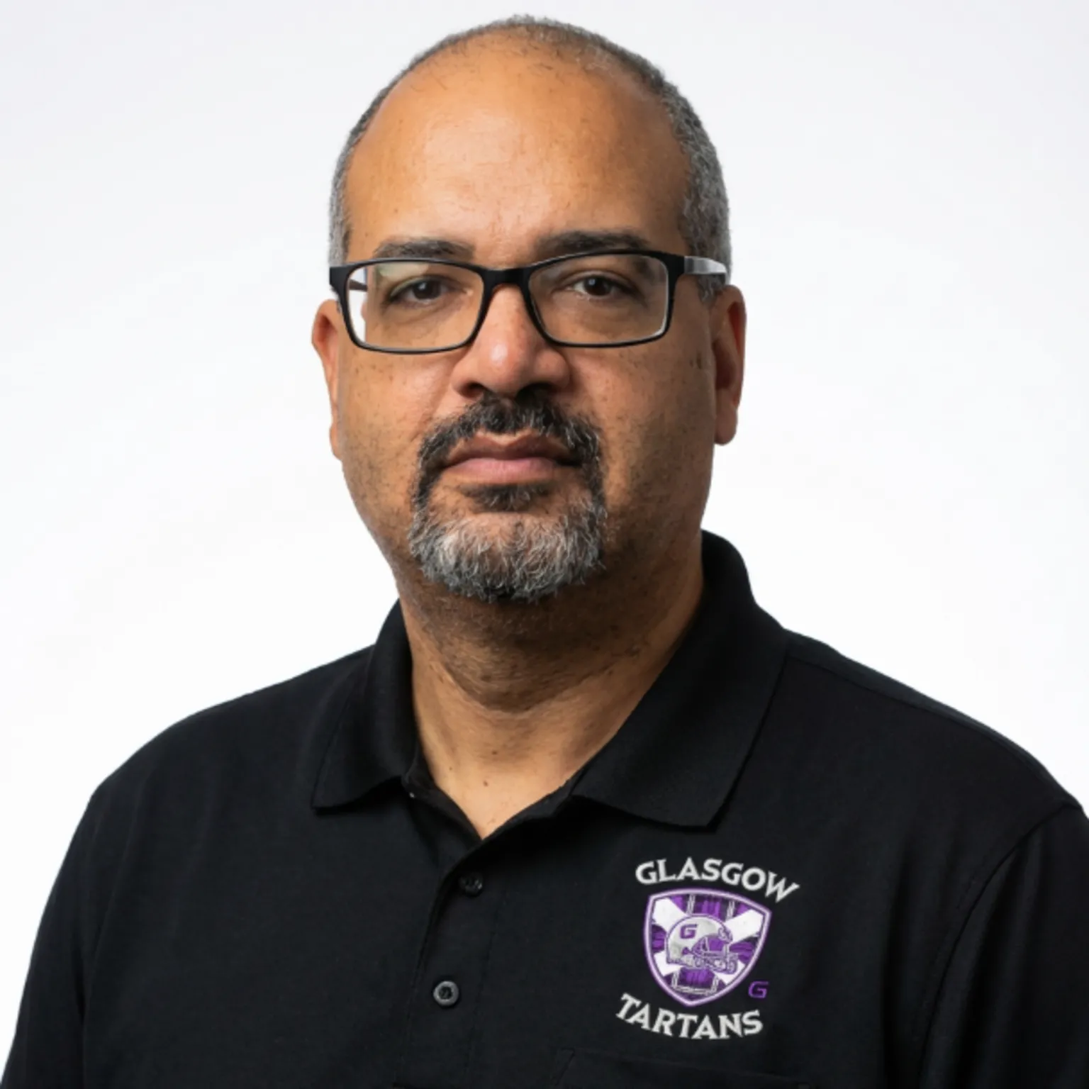 IAL Bennett Johnson - a man with greying, thin hair, a beard and glasses, looking straight into the camera.