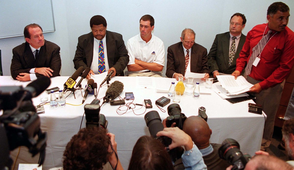 South African cricket captain Hansie Cronje, with arms folded, at a news conference in Cape Town.
