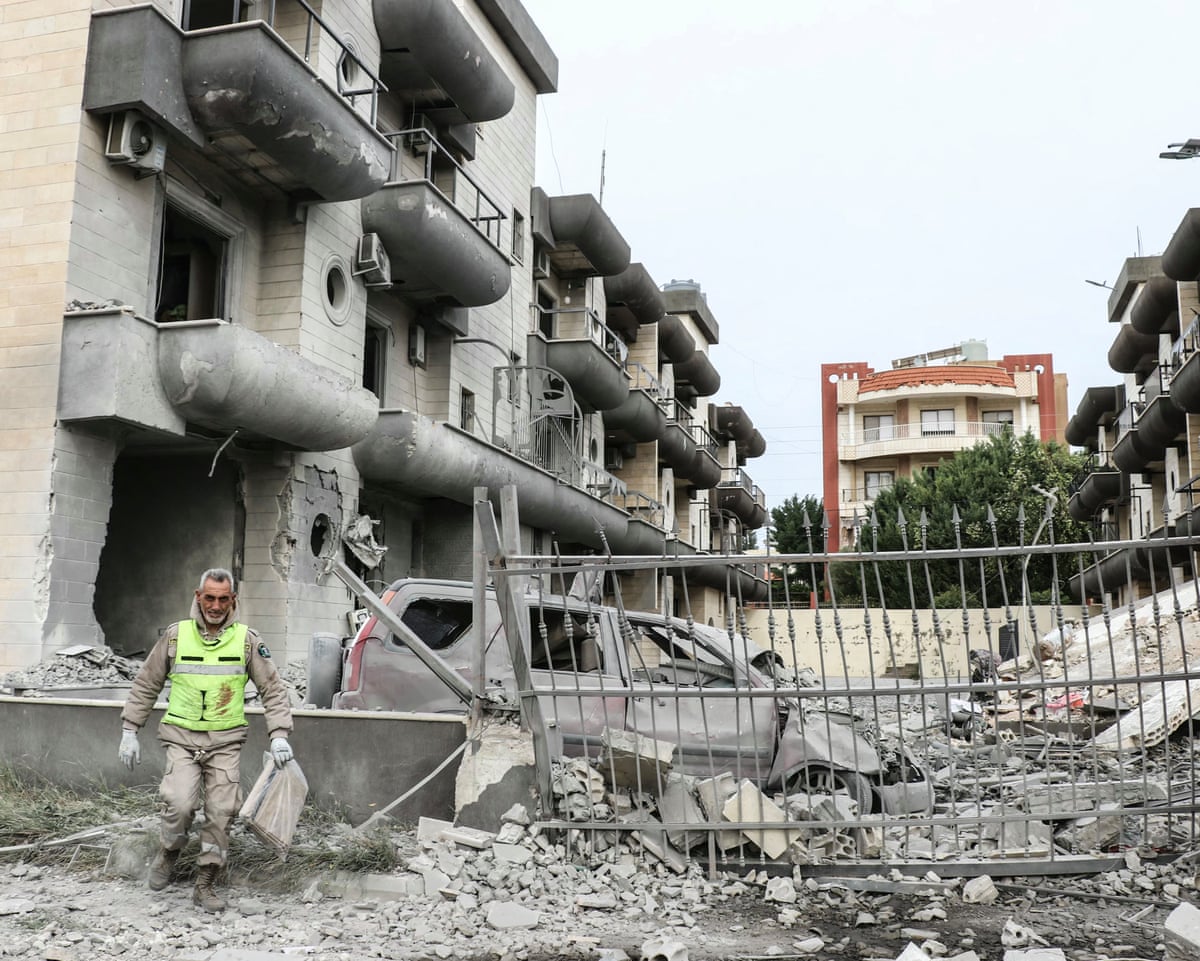 A first responder inspects the site of an Israeli airstrike in the southern Lebanese village of Abbasiyeh, on the outskirts of Tyre, on Wednesday