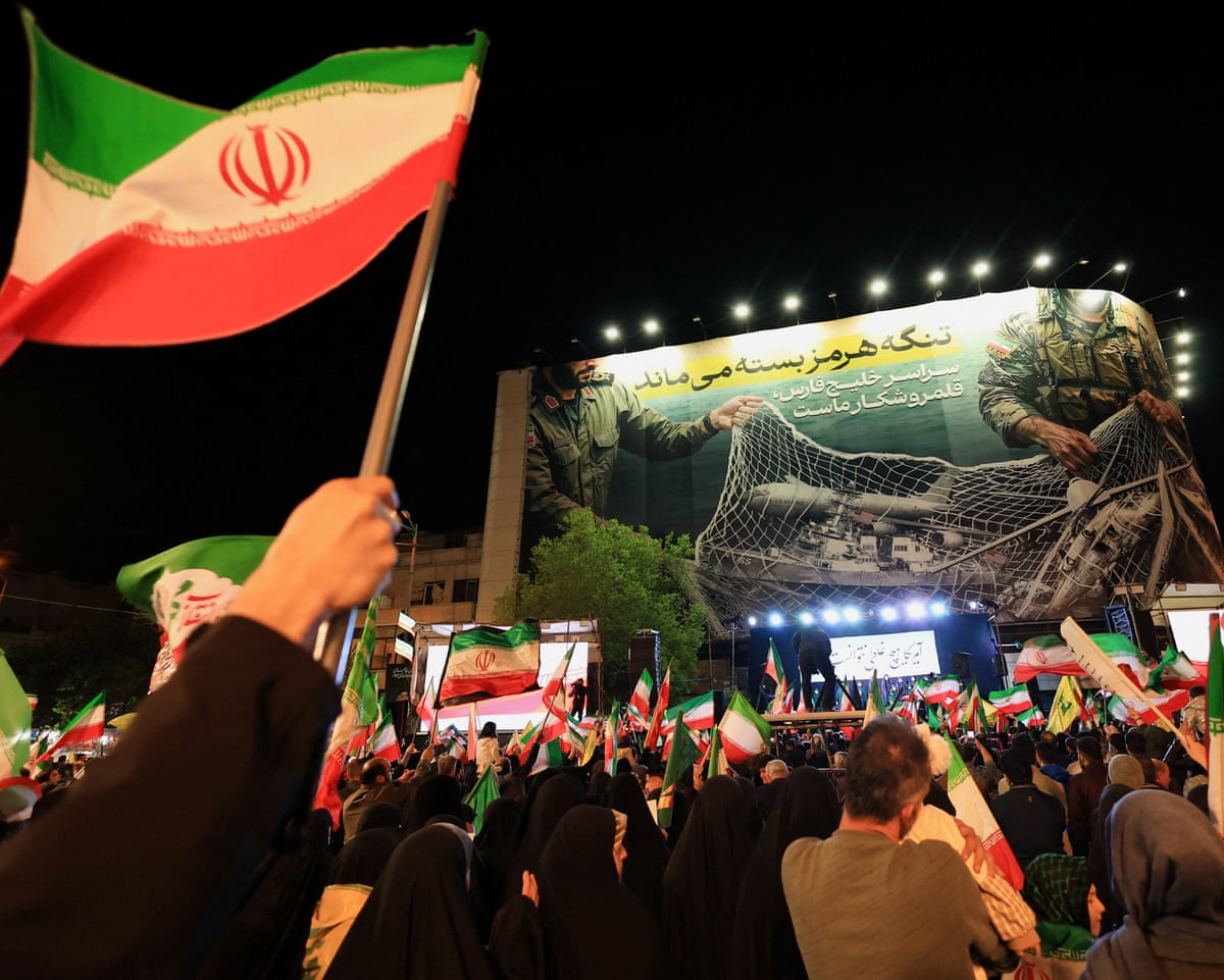 People take part in an anti-US and Israel rally in Tehran’s Enghelab Square