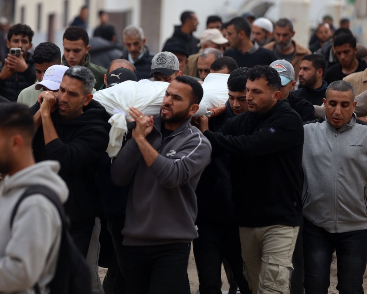 Mourners carry the body of a Palestinian medis says was killed in an Israeli strike, during a funeral procession at Al Shifa Hospital in Gaza City, Gaza