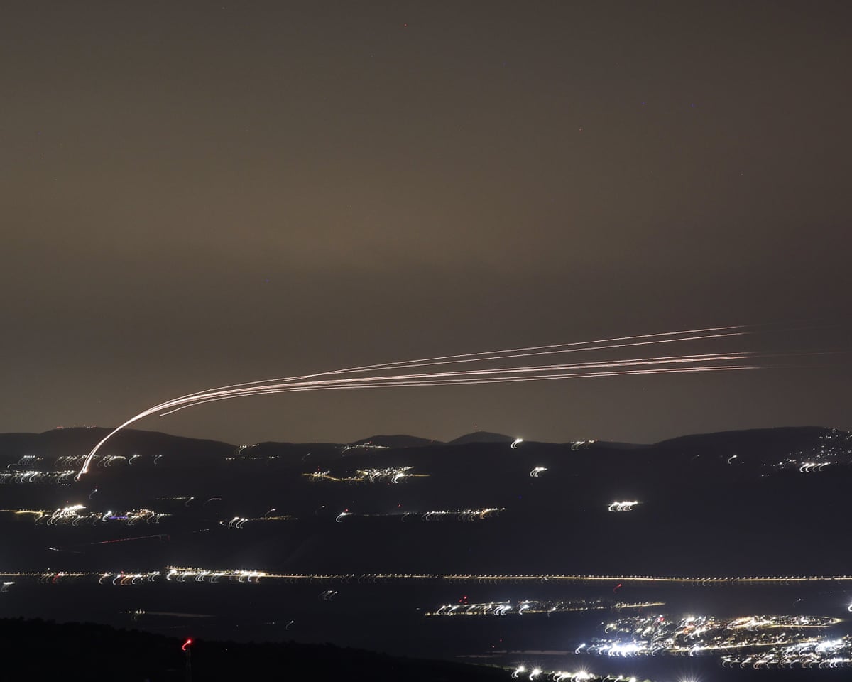 Israeli air defence systems intercept projectiles over the Upper Galilee region in northern Israel
