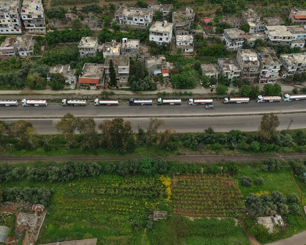 A line of Iraqi diesel-laden tanker trucks lined up along the Tartus-Baniyas highway as they wait to unload their cargo at the Baniyas port refinery in Syria