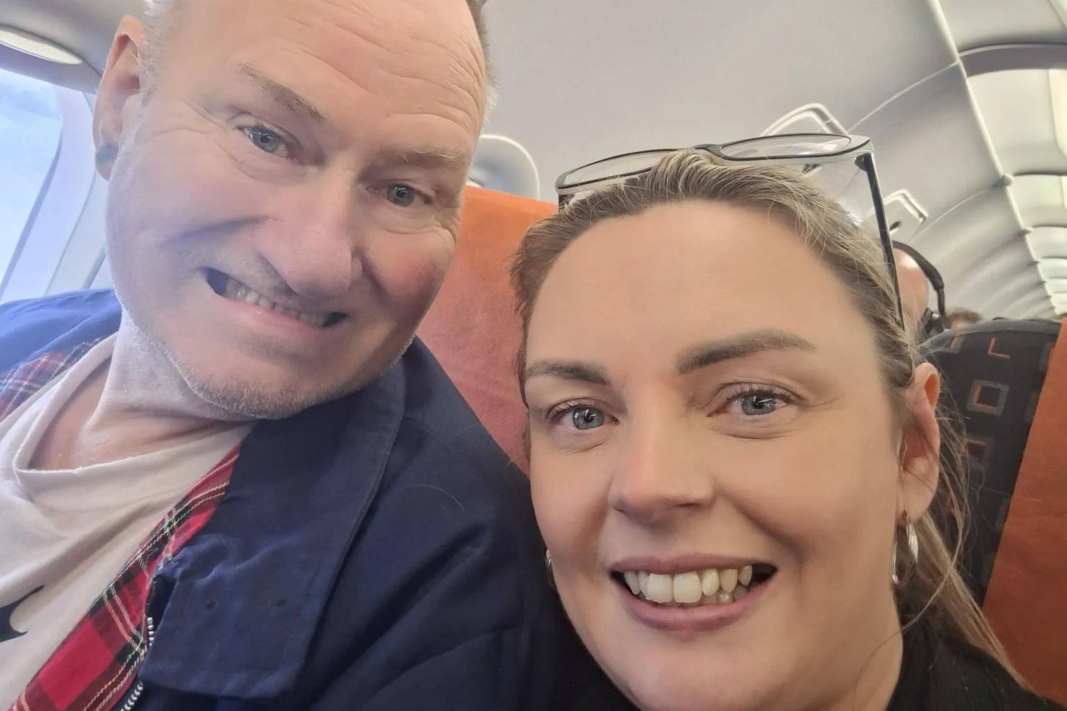 Supplied A man and a woman smiling for a selfie while on a flight