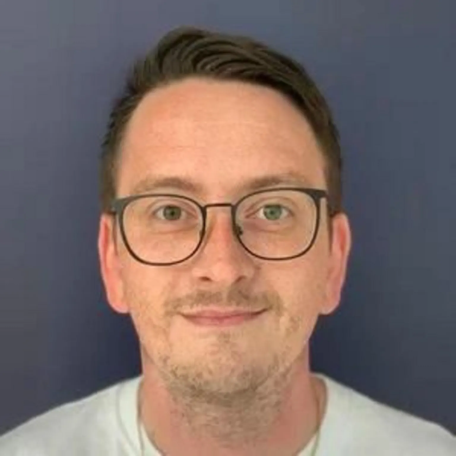 Liam Grimes Liam Grimes - a man in a white t-shirt and glasses