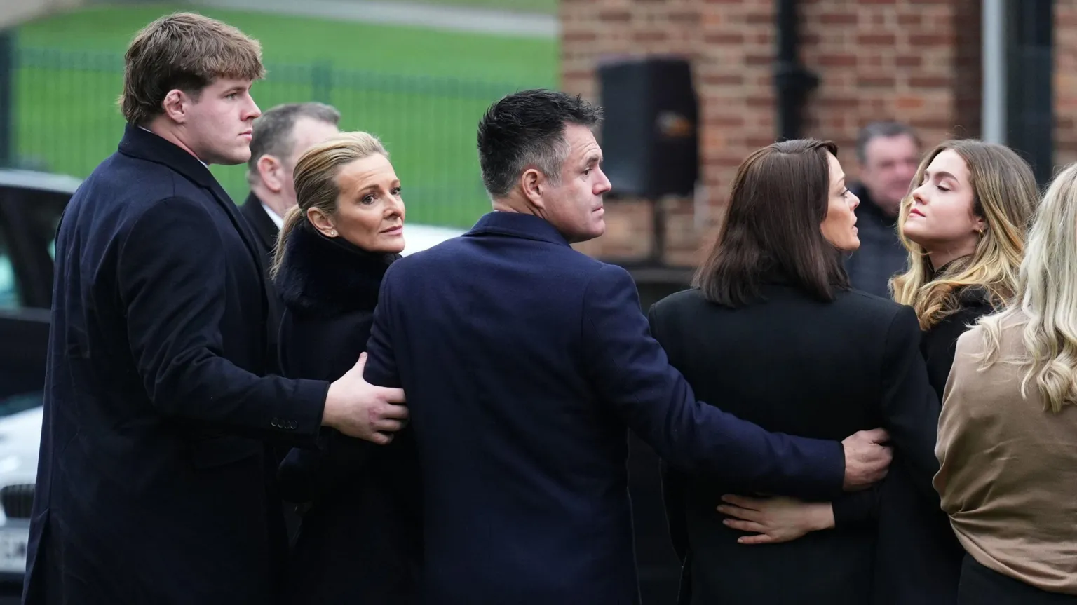  Terry Yorath's funeral with Gabby Logan looking over her shoulder with her family around her including son Reuben standing behind her with his arm around her 