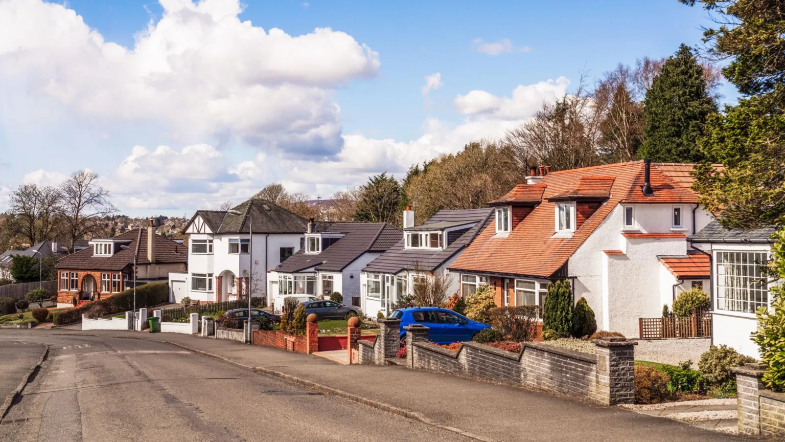  A street of large houses, framed by mature trees, in the affluent Glasgow suburb of Bearsden