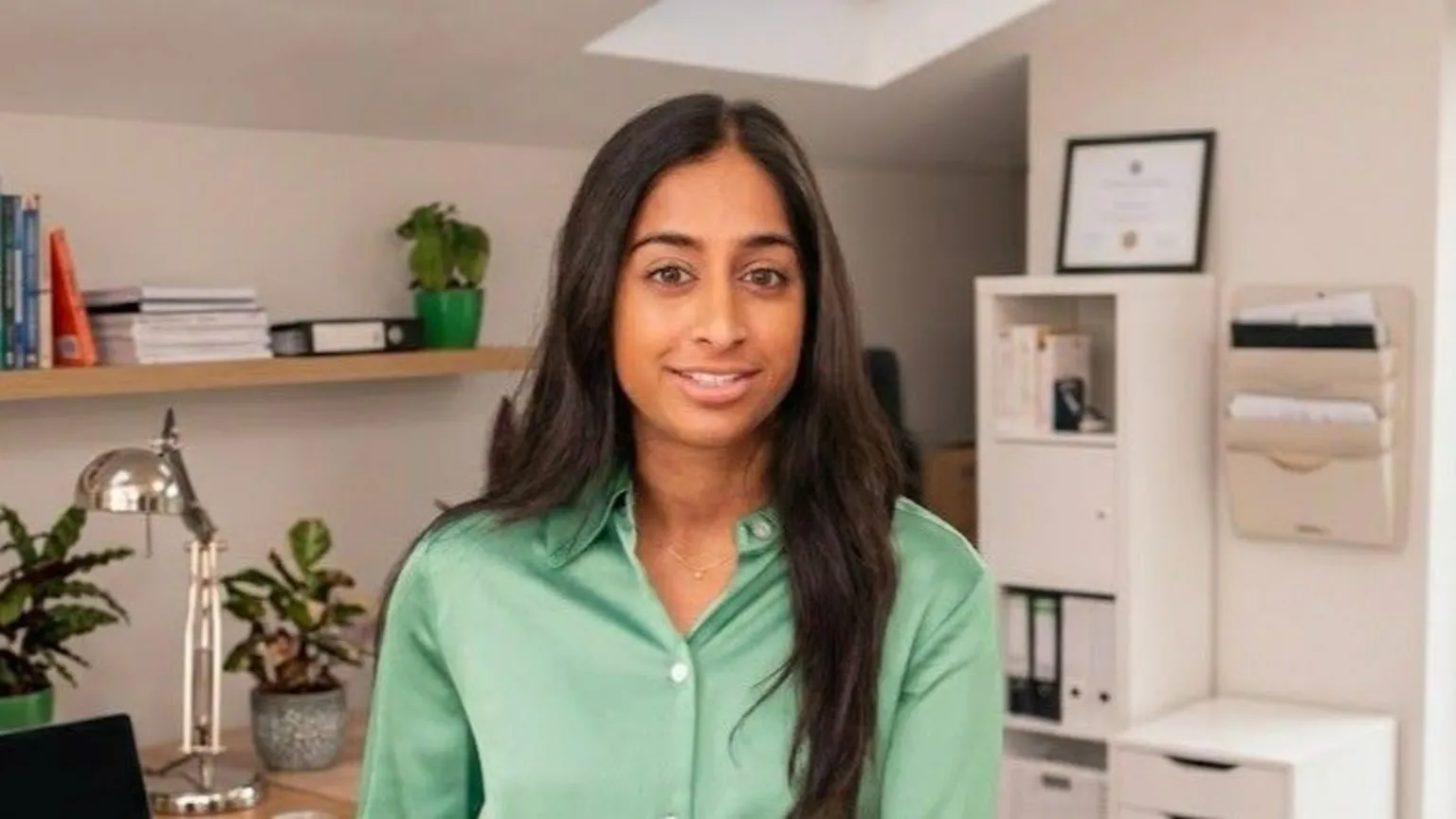 Bellevue Law Anjali Malik has long black hair and wears a green shirt