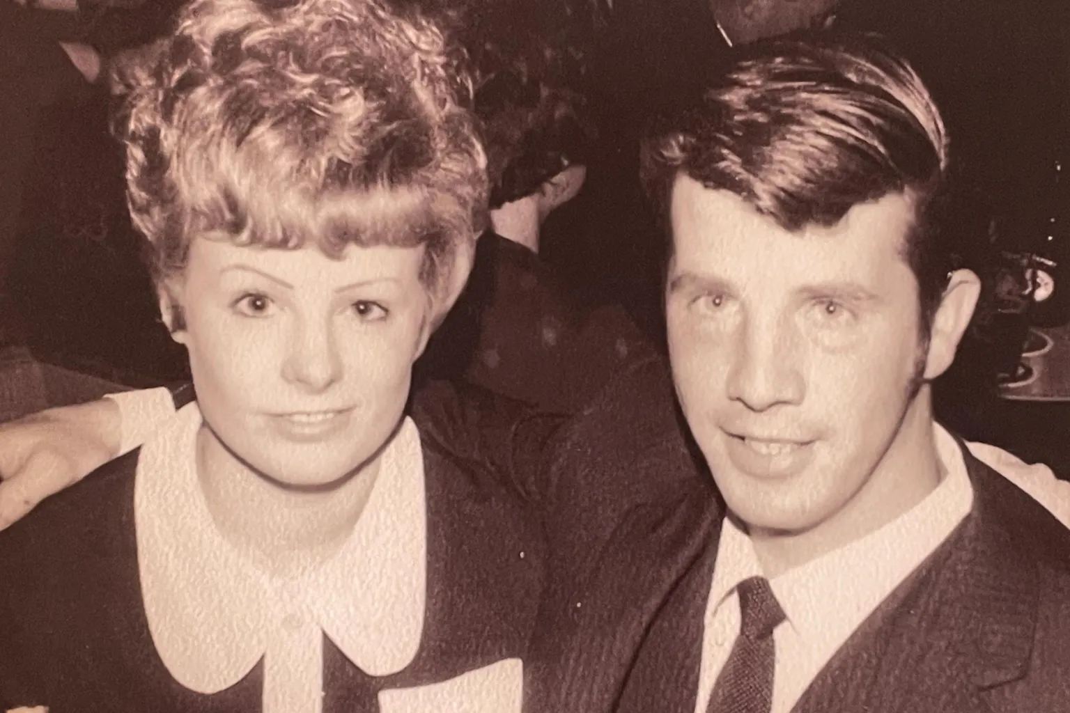Jim Moir An image from the 1960s or Gladys and Jimmy - in black and white Gladys on the left with her blonde hair piled on her head and a Peter Pan collar dress, Jimmy with a stylish quiff and a suit and tie.
