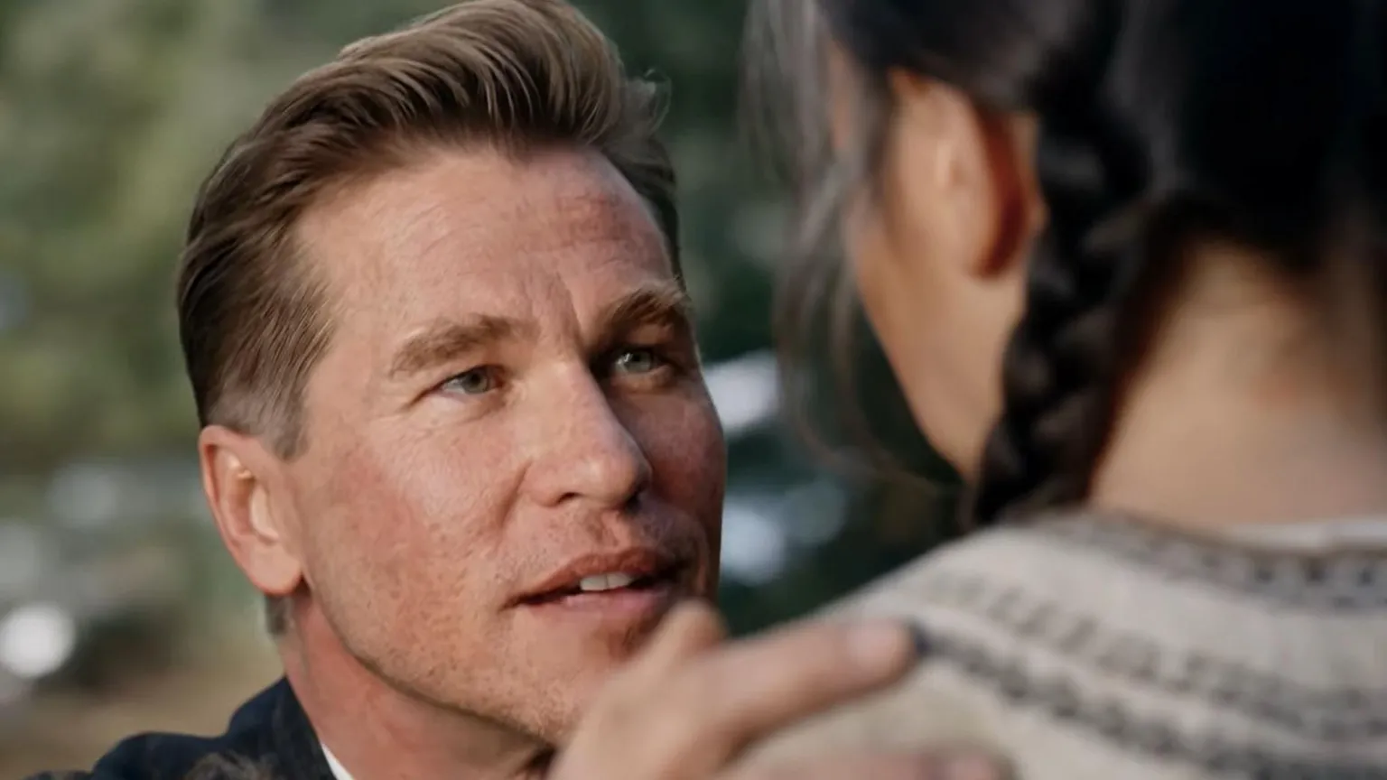 First Line Films Val Kilmer kneeling in front of a girl with a hand on her shoulder and speaking to her