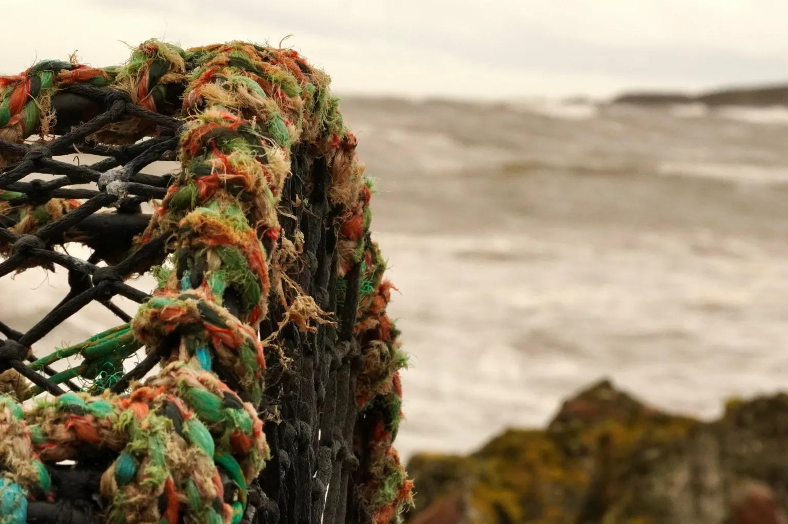 Sarah Sivers A stack of creels with sea and coastline in the distance.