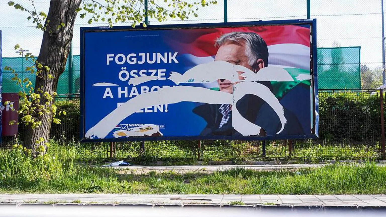SOPA Images/LightRocket via A torn political poster featuring Hungarian leader Victor Orban is seen near the polling station.