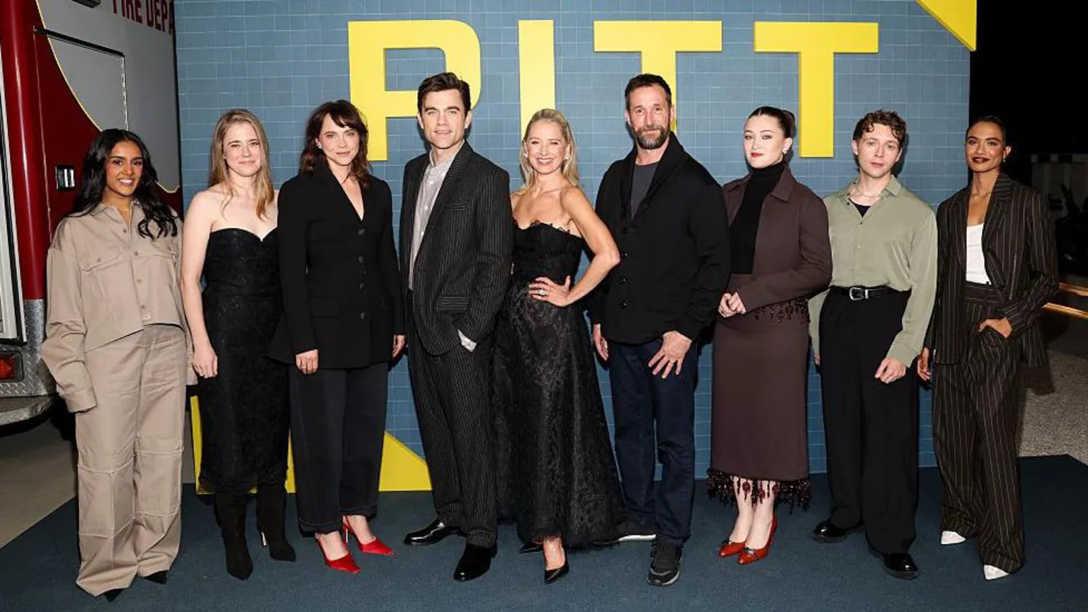 The cast of The Pitt on the red carpet smiling for photos.