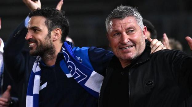 Cesc Fabregas and Osian Roberts celebrate Como 1907's promotion to Serie A in 2024. 