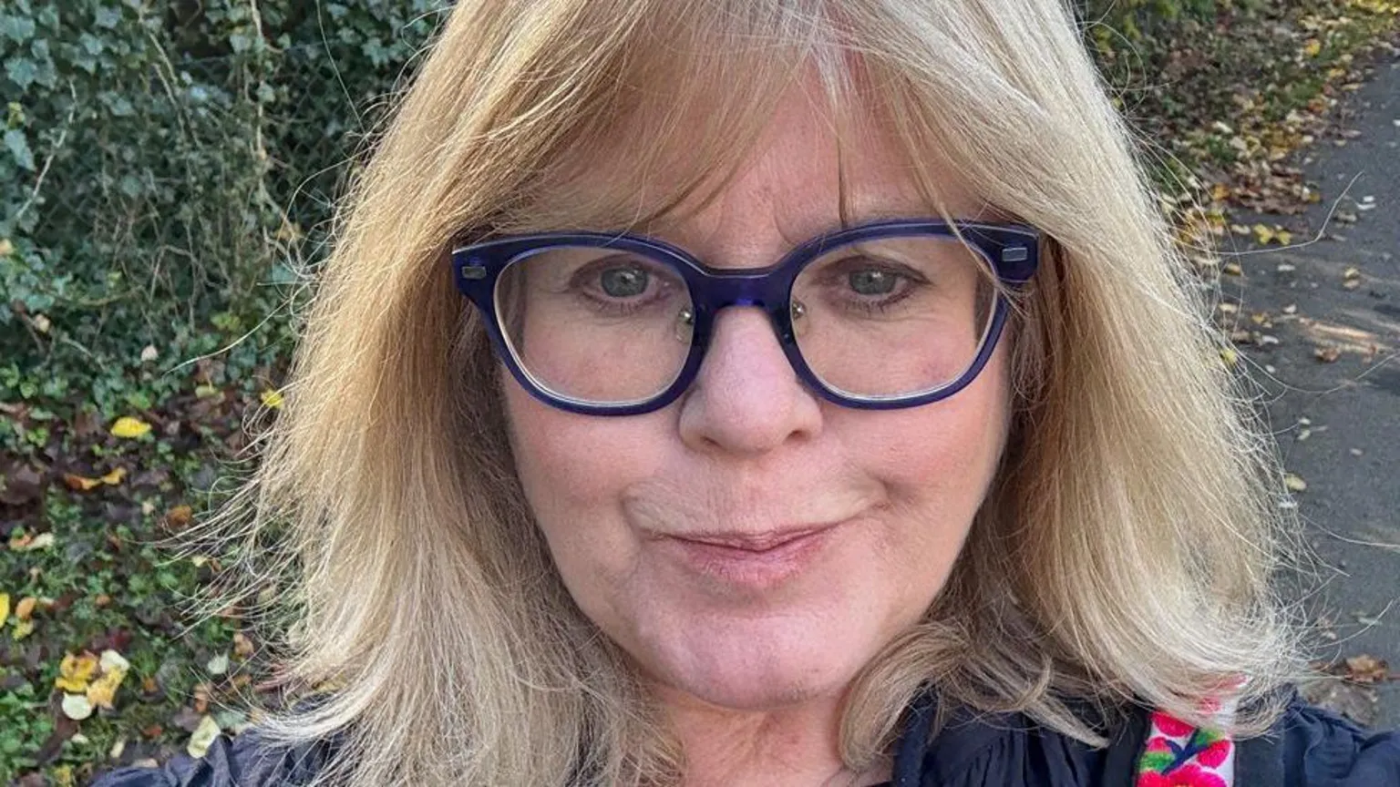 Jane Rae A woman with medium-length blonde hair smiles into the camera