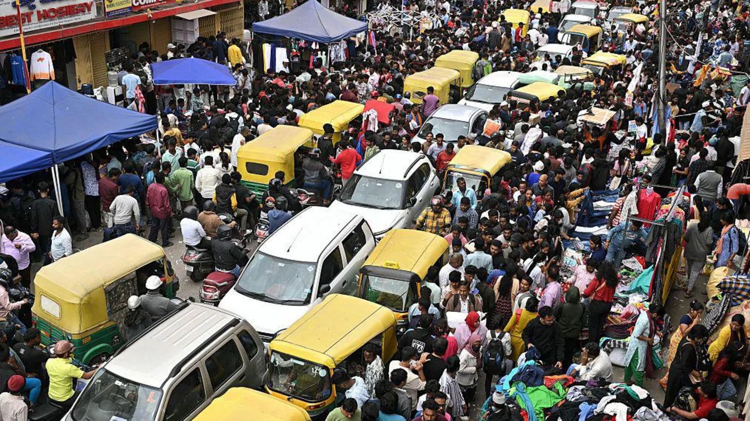AFP via Traffic jam at Chickpet market in Bengaluru on 11 January, 2026. Tuk-tuks, cars and swarms of people can be seen blocking a road. 