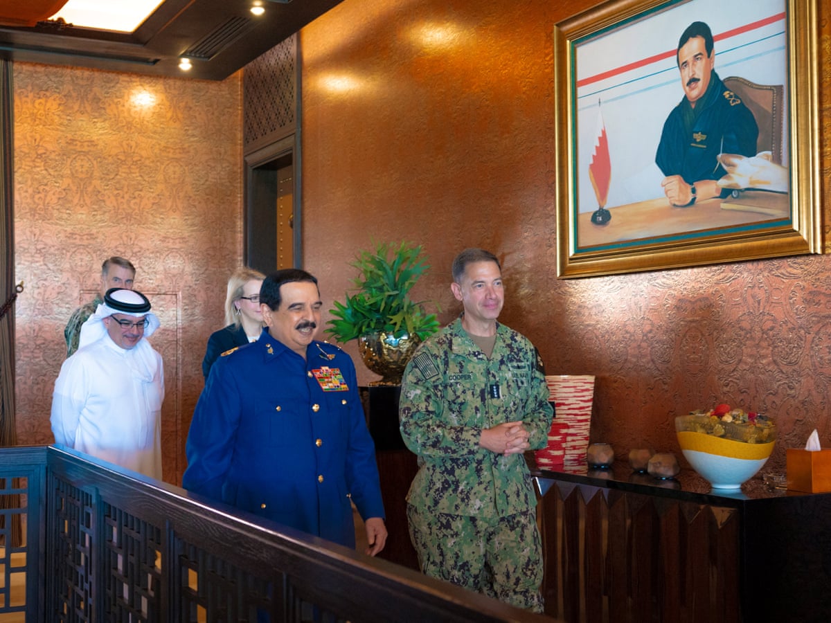 Bahrain’s King Hamad bin Isa al-Khalifa walks with Adm Brad Cooper