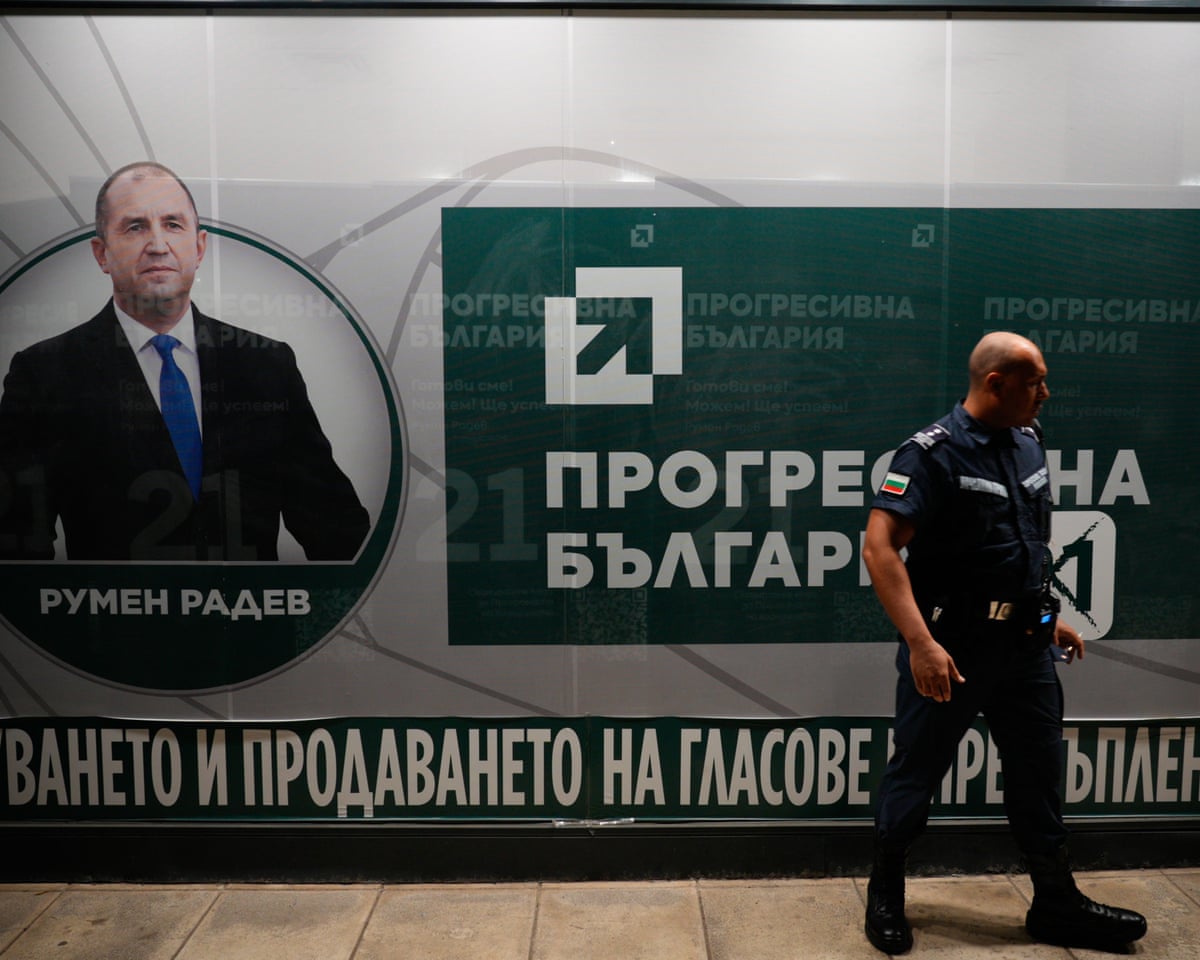 A member of the Gendarmerie special police stands guard in front of the Progressive Bulgaria party headquarters after countrywide polls have closed in Sofia, Bulgaria.