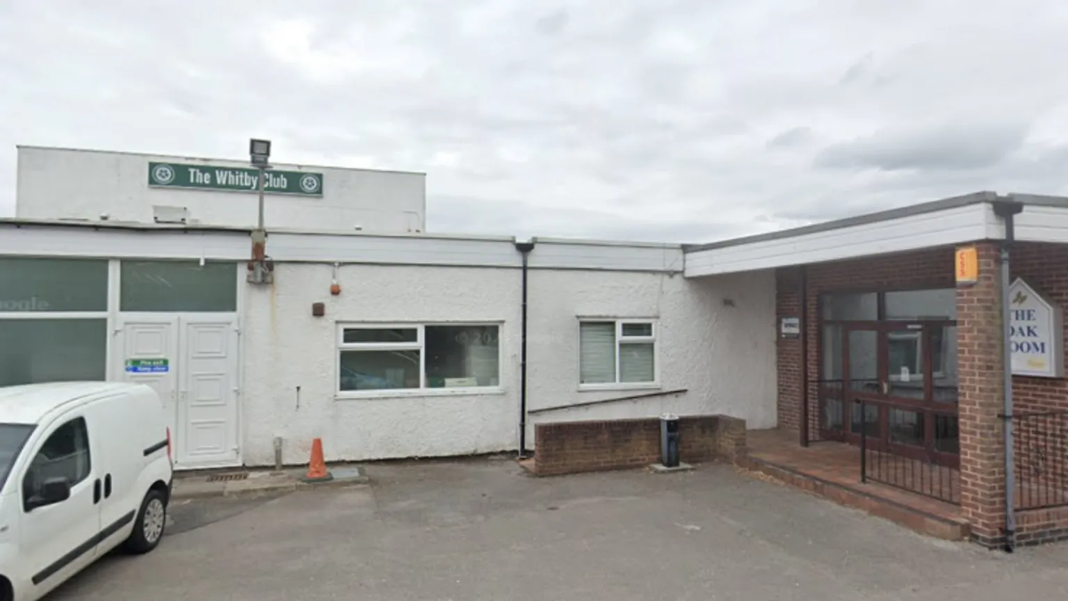 Google View of social club, white brick building