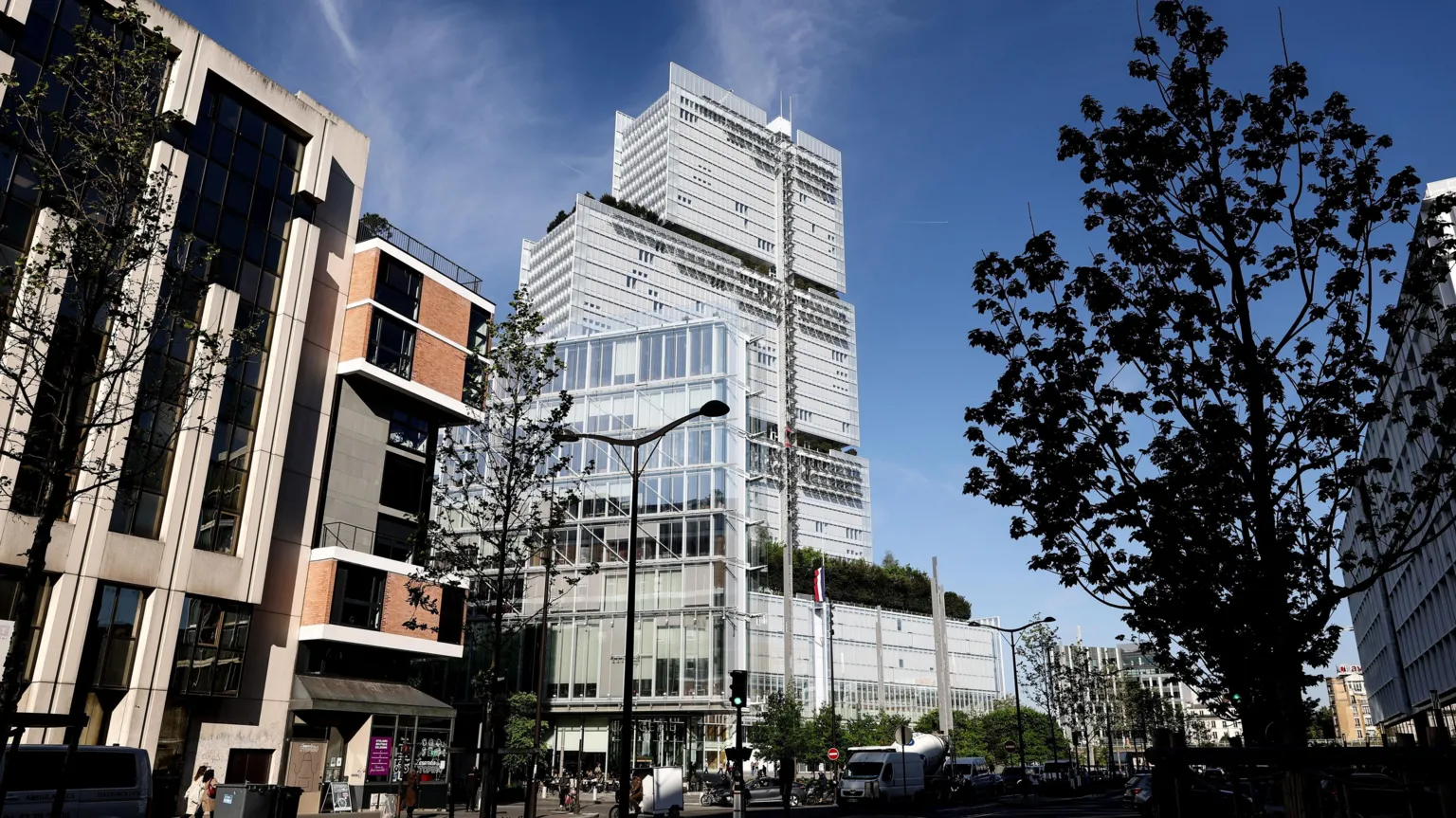 EPA The Paris Court of Justice, a tall building fronted by steel and glass, seen from street level against a clear blue sky
