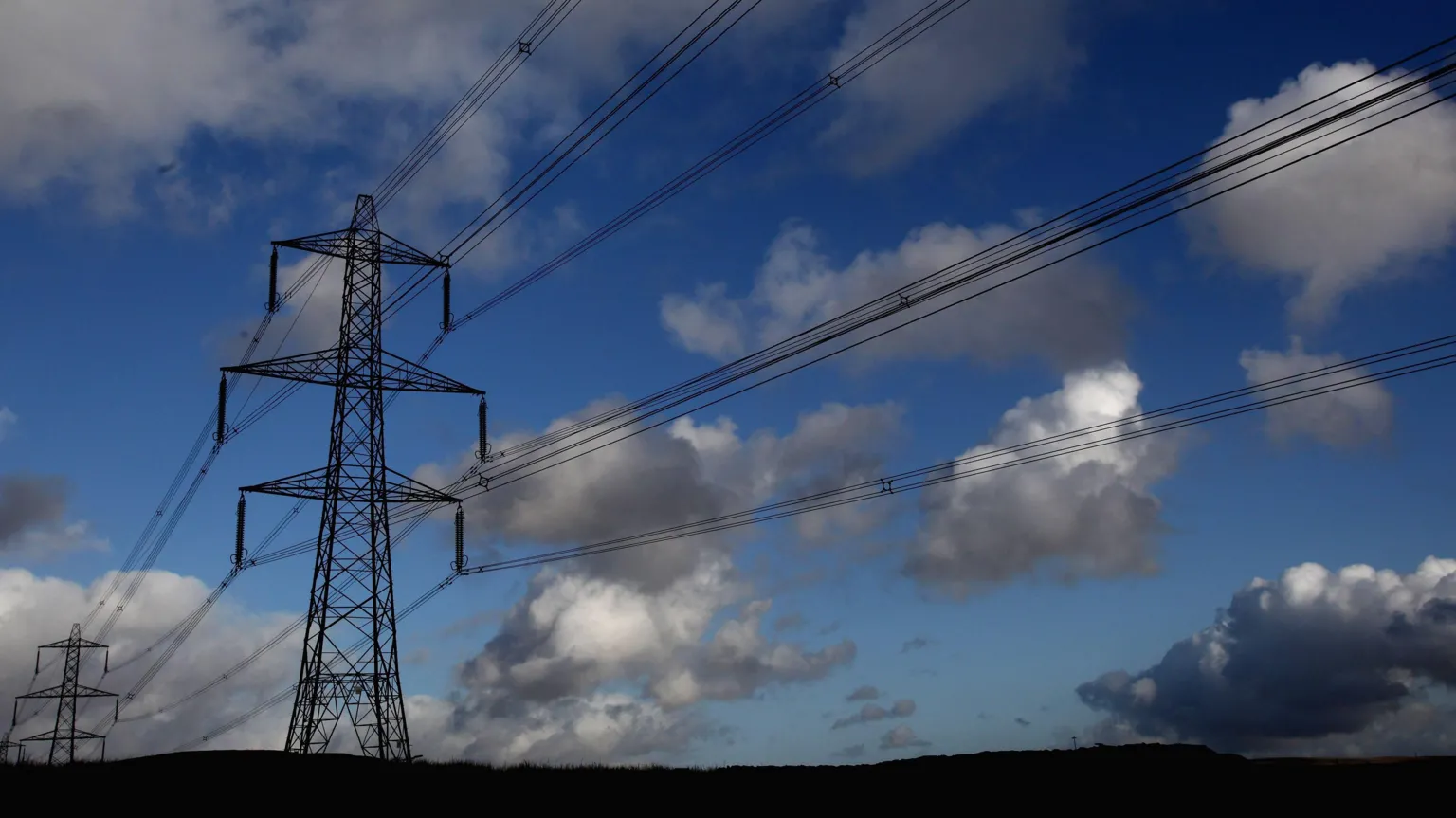 Matt Cardy/ Electricity pylons stand near the Ffos-y-Fran opencast coal mine on November Merthyr Tydfil, Wales.