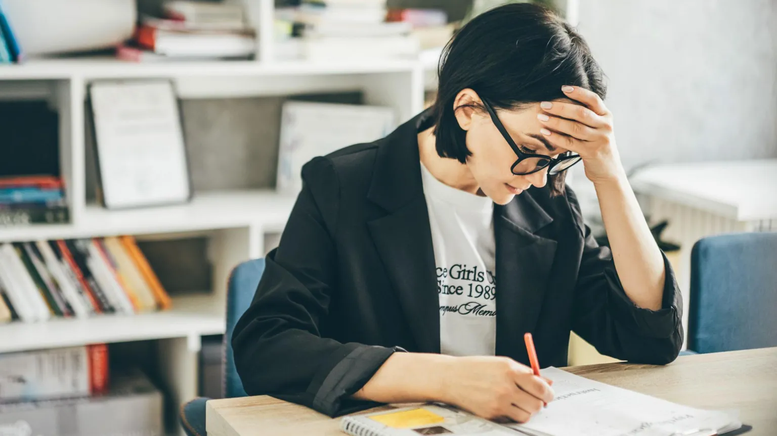  Teacher at a desk with head in hands