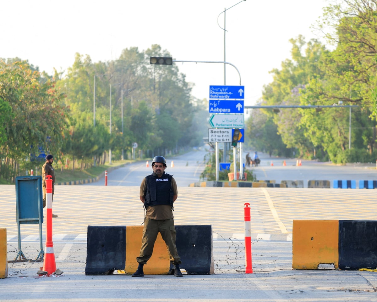 Police stand guard on a road leading to the Serena hotel in Islamabad as Pakistan prepares to host a second-round of US-Iran talks, despite uncertainly over the meeting will occur