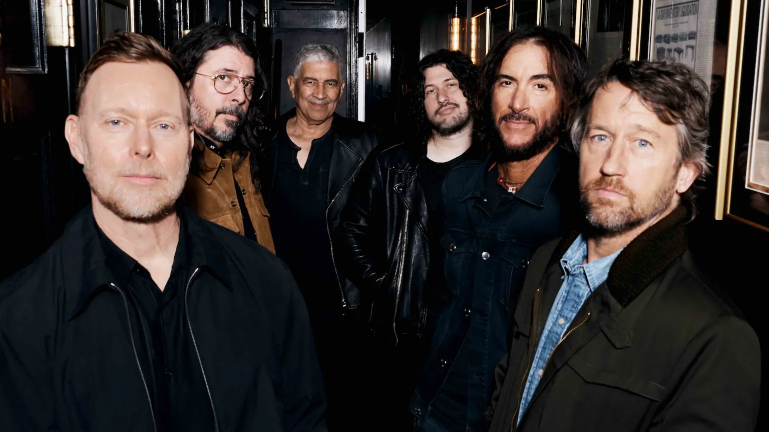 Elizabeth Miranda A promotional photograph of the Foo Fighters, showing the band lined up in a wood-panelled corridor, surrounded by picture frames