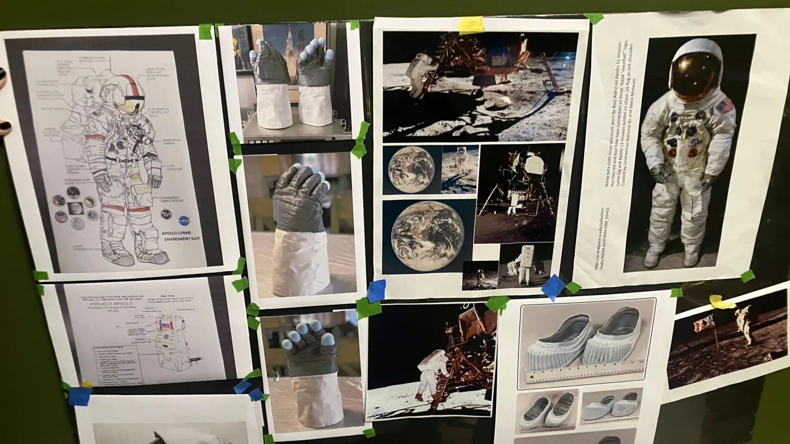 Pictures of the Moon and spacesuits hung up on a wall. 