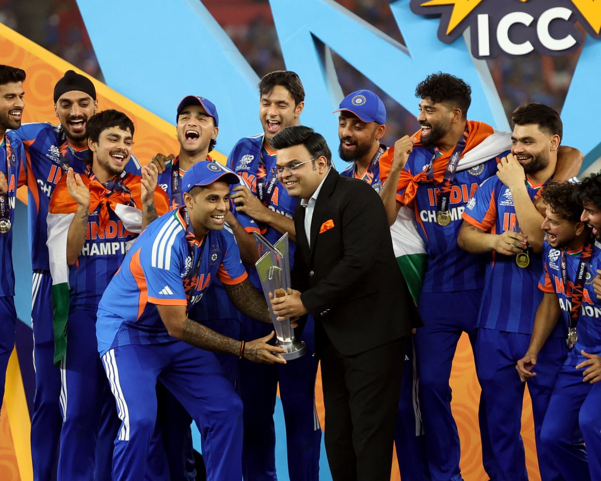 Suryakumar Yadav and Jay Shah lift the trophy after the ICC men’s T20 World Cup match between India and New Zealand