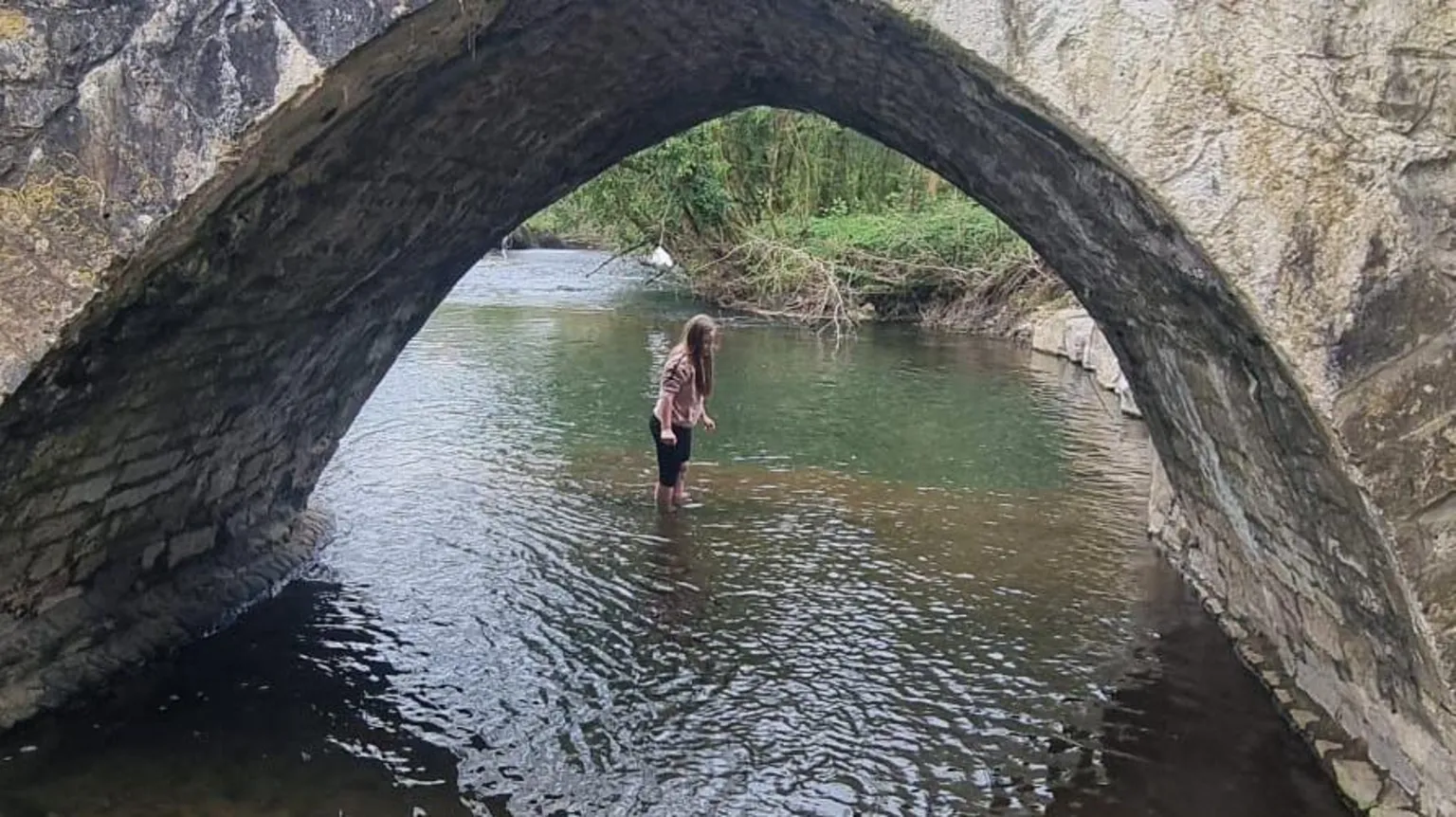 Melanie Hill Evie in the River Ogmore under a bridge 