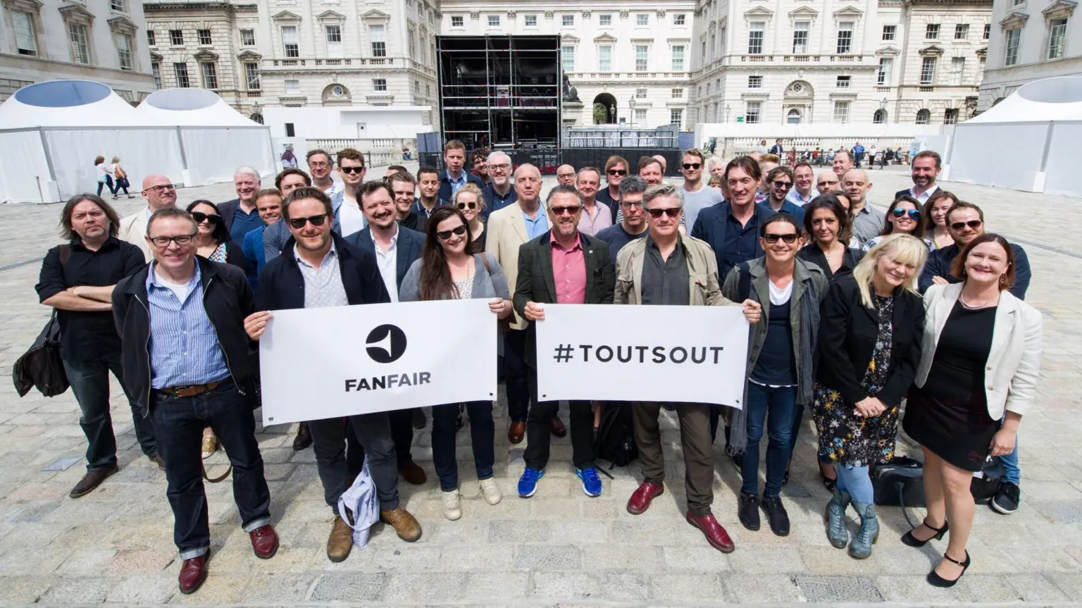 The FanFair Alliance A large group of people from FanFair Alliance, holding a sign which reads 