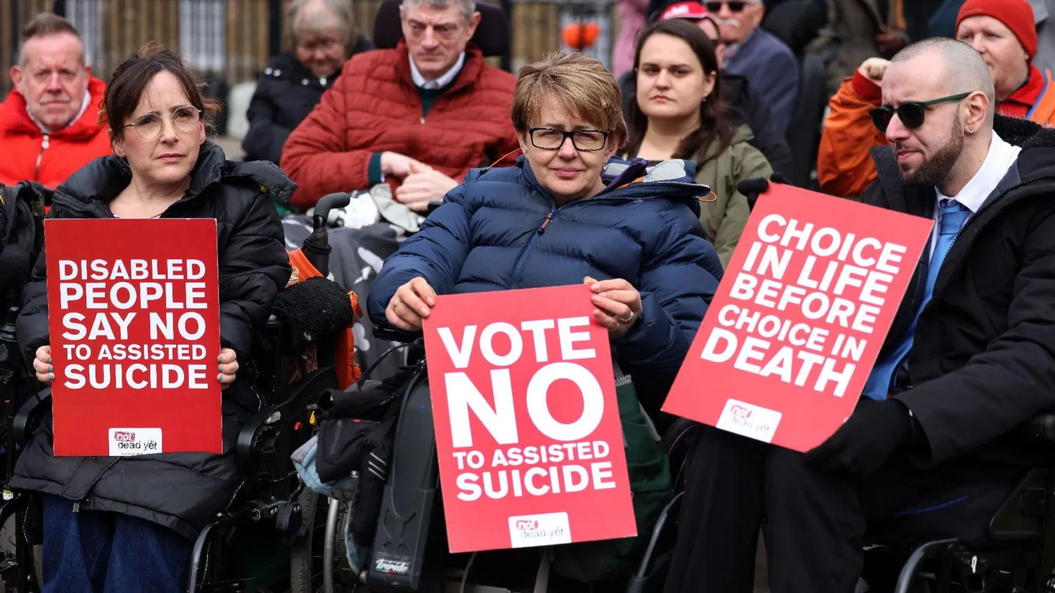 EPA Baroness Tanni Grey-Thompson holds a red placard reading: 