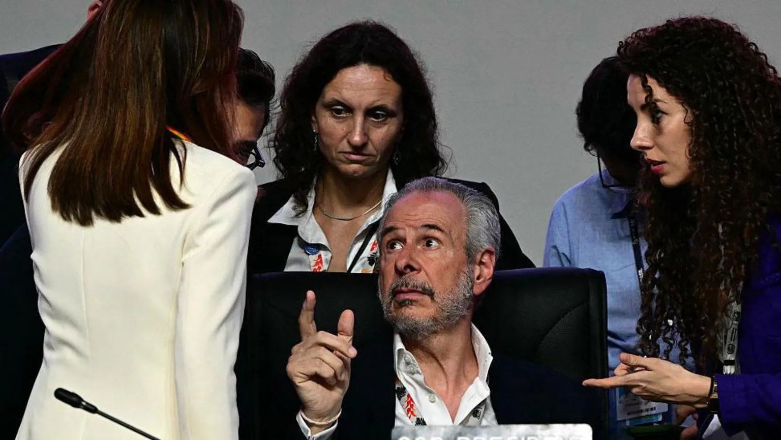 Getty A group of men and women in heated, animated discussion in the final hours of COP30 in Brazil in November 2025