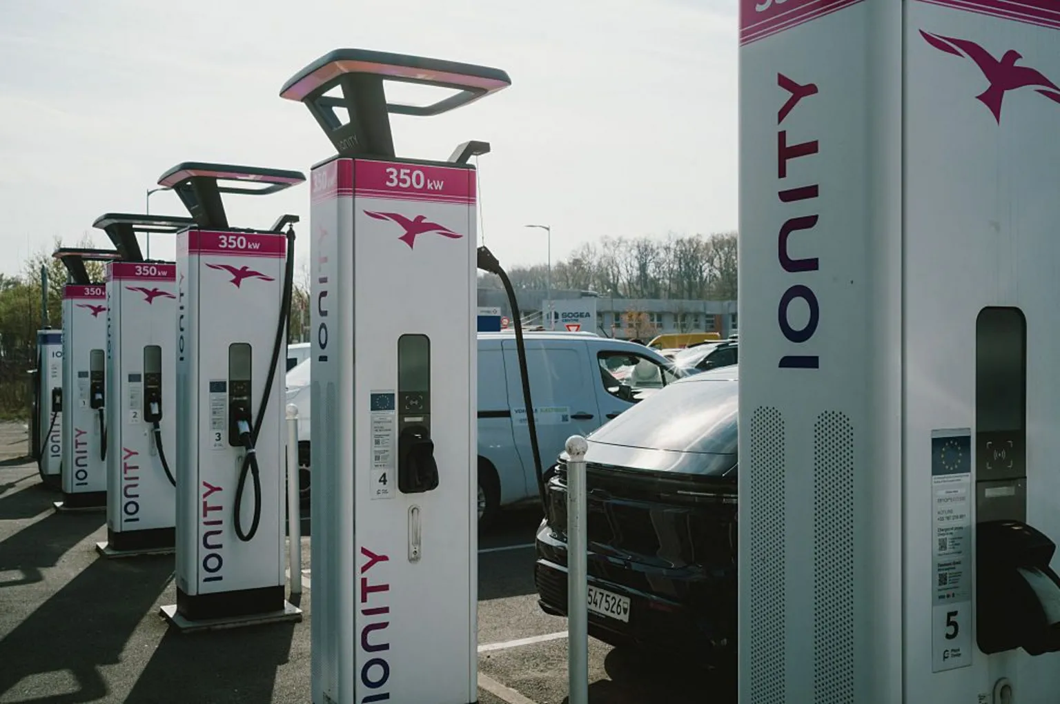  A number of electric vehicles are being charged at a line of charging stations in France, as sales of EVs soar due to concerns over fossil fuel supplies